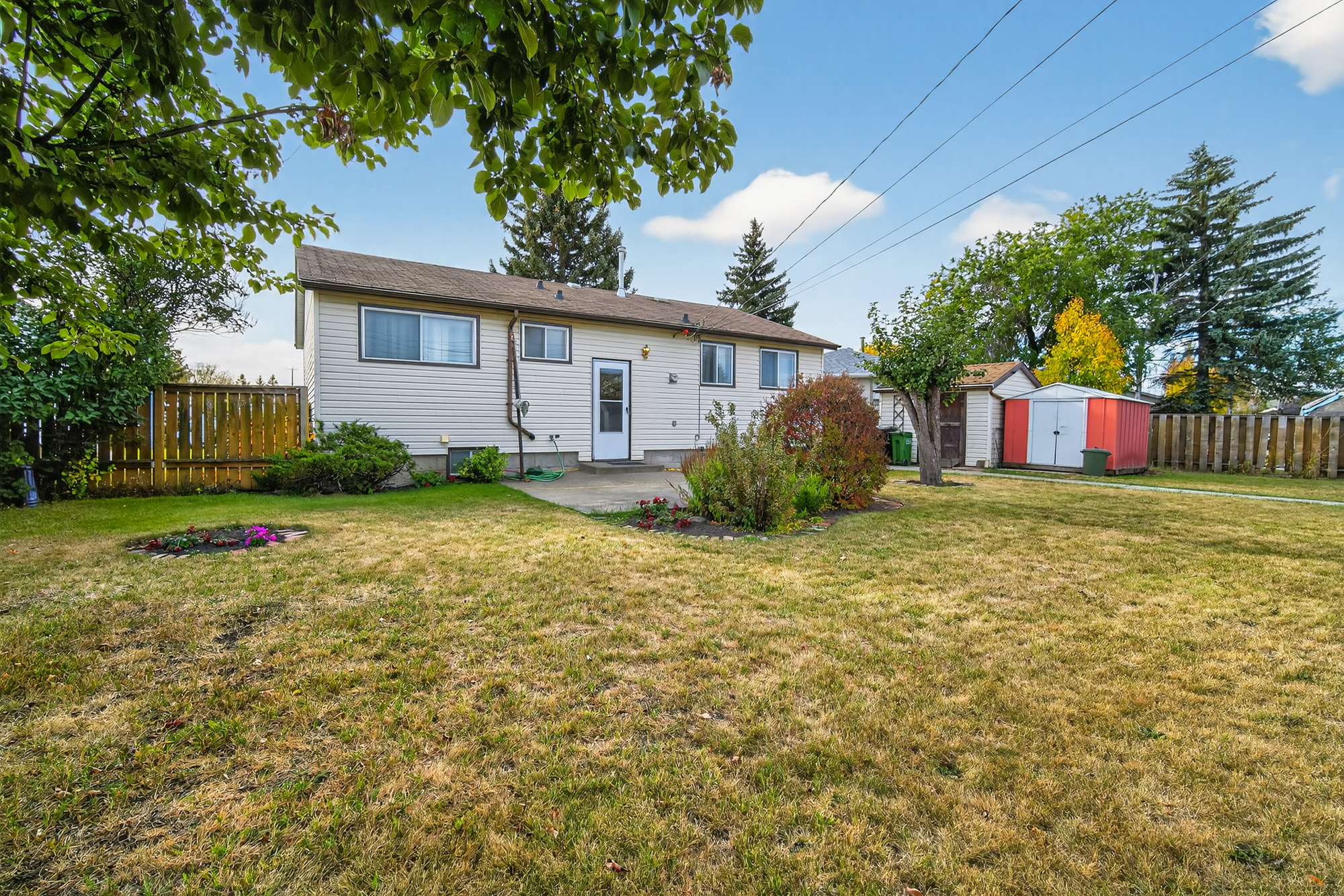 Kensington Edmonton bungalow with large pie-shaped backyard, garden, and double detached garage — listed by Corey Sylvester, Sylvester Realty Group.